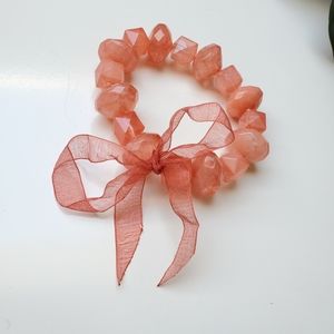 Aldo coral beaded bracelet with a bow